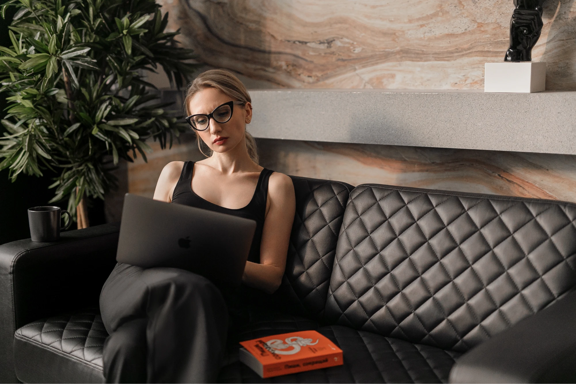 Woman on couch with laptop